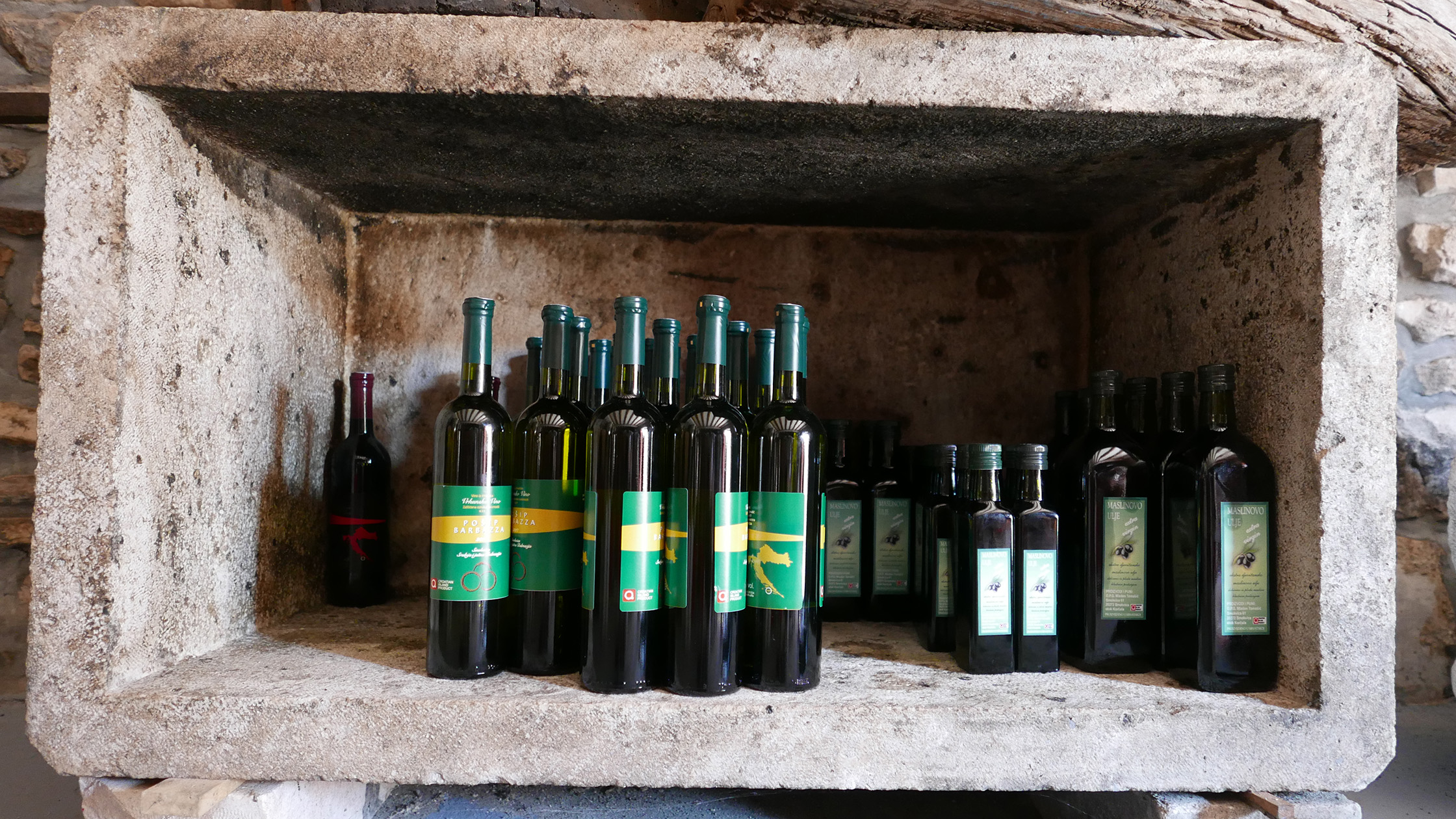 Wine bottles laid down in the stone niche cut into the cellar wall