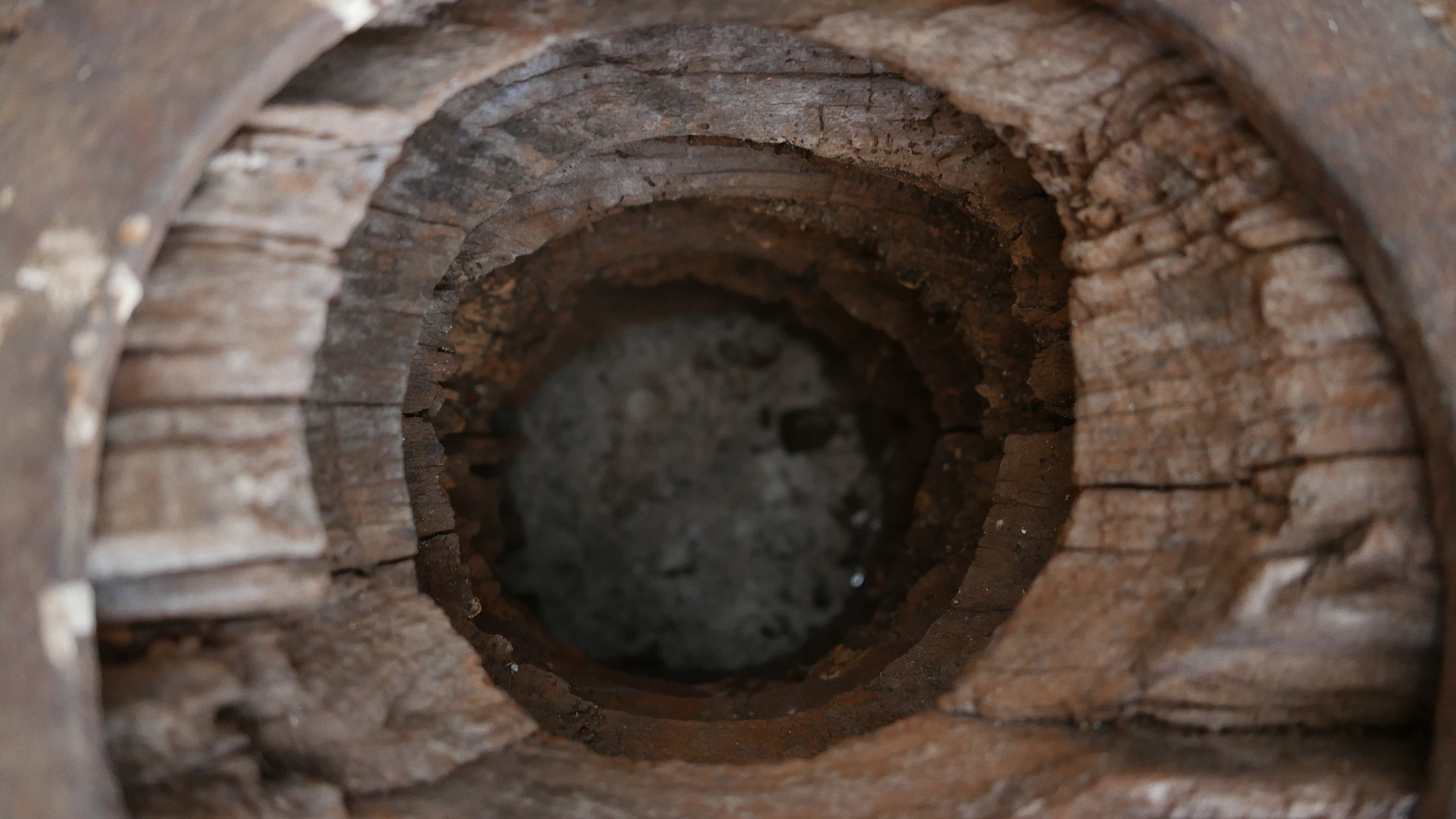 The stone well cut into limestone in the cellar corner
