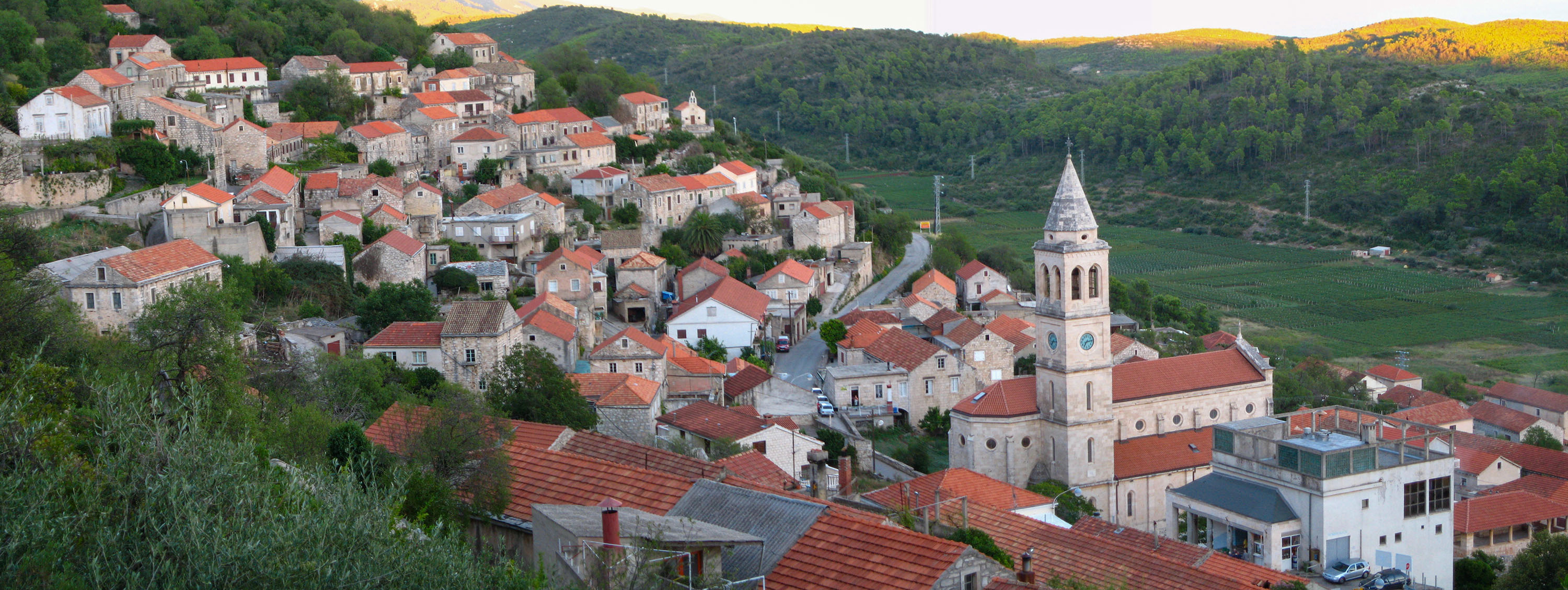 The village of Smokvica spread across the green Korčula hills, the bell-tower of Our Lady of the Snows at its heart